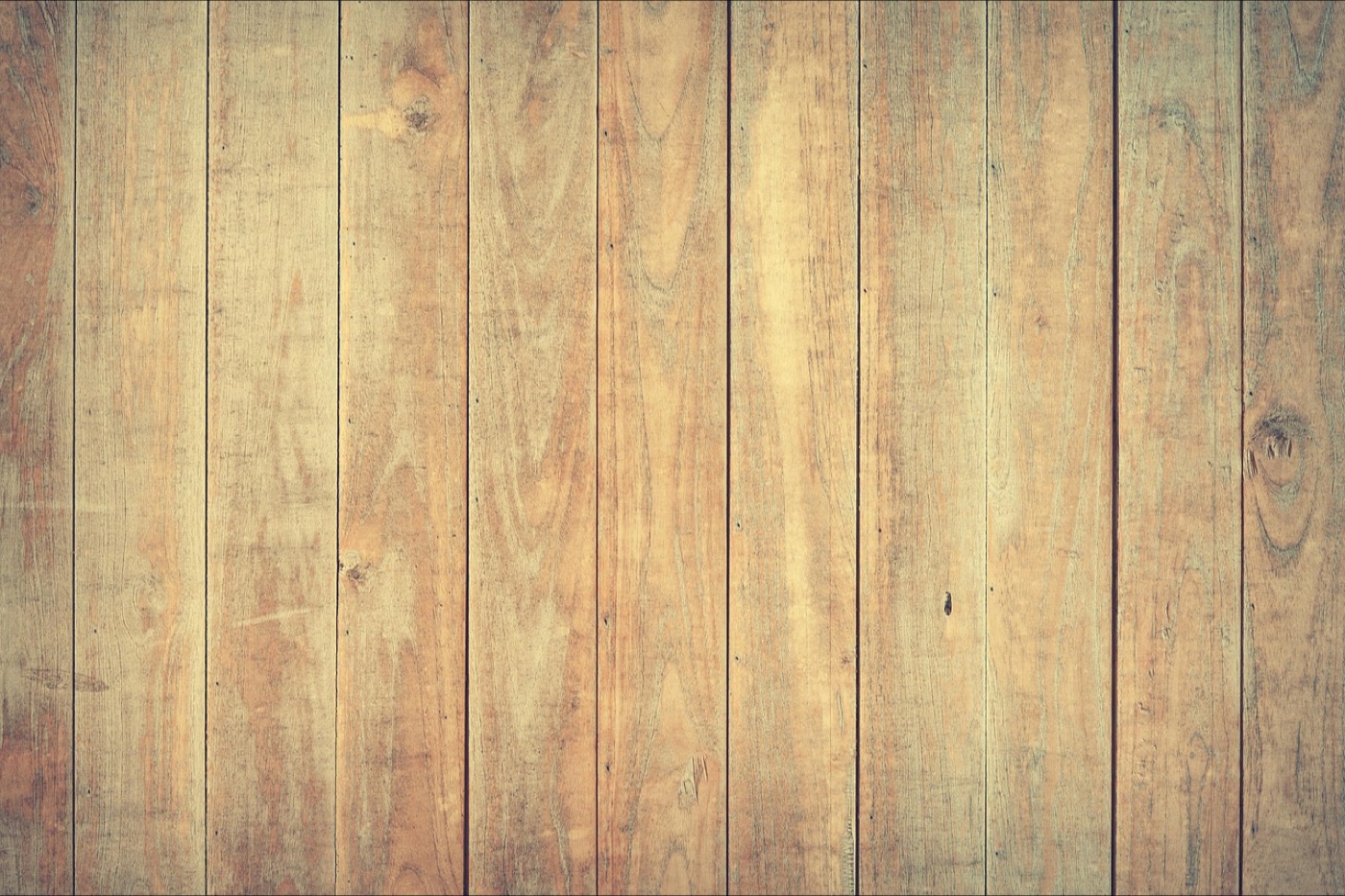 A wide expanse of worn oak floorboards showing the plank joints and grain, used as a measuring surface.