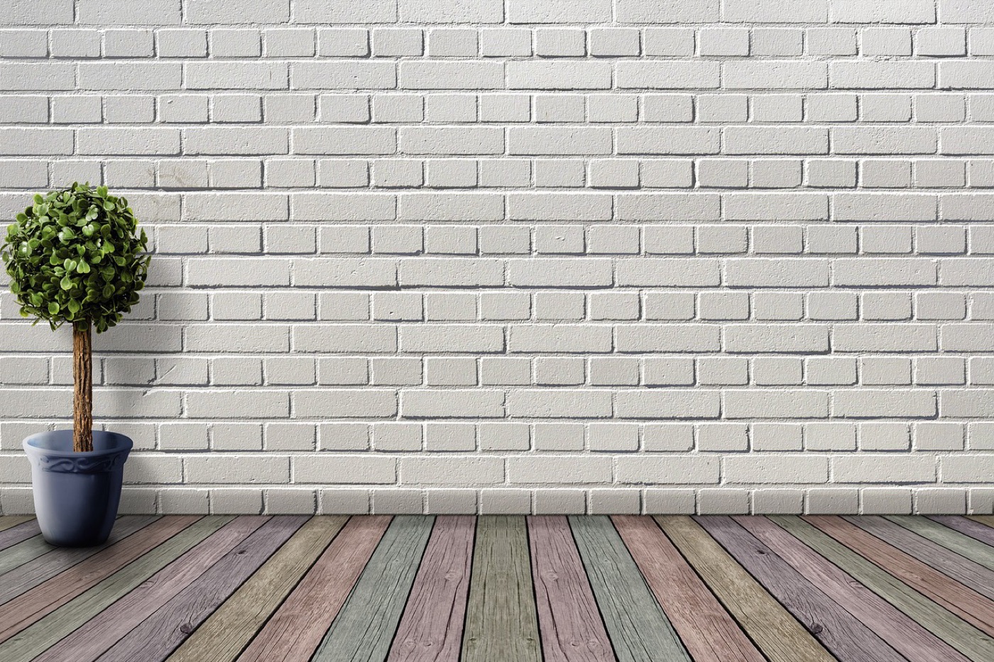 An empty room with a bare wood floor, no furniture, the full floor surface visible from wall to wall.